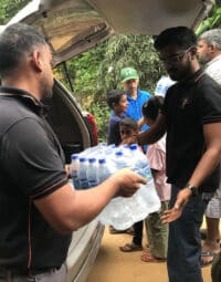 man-handing-water-bottles